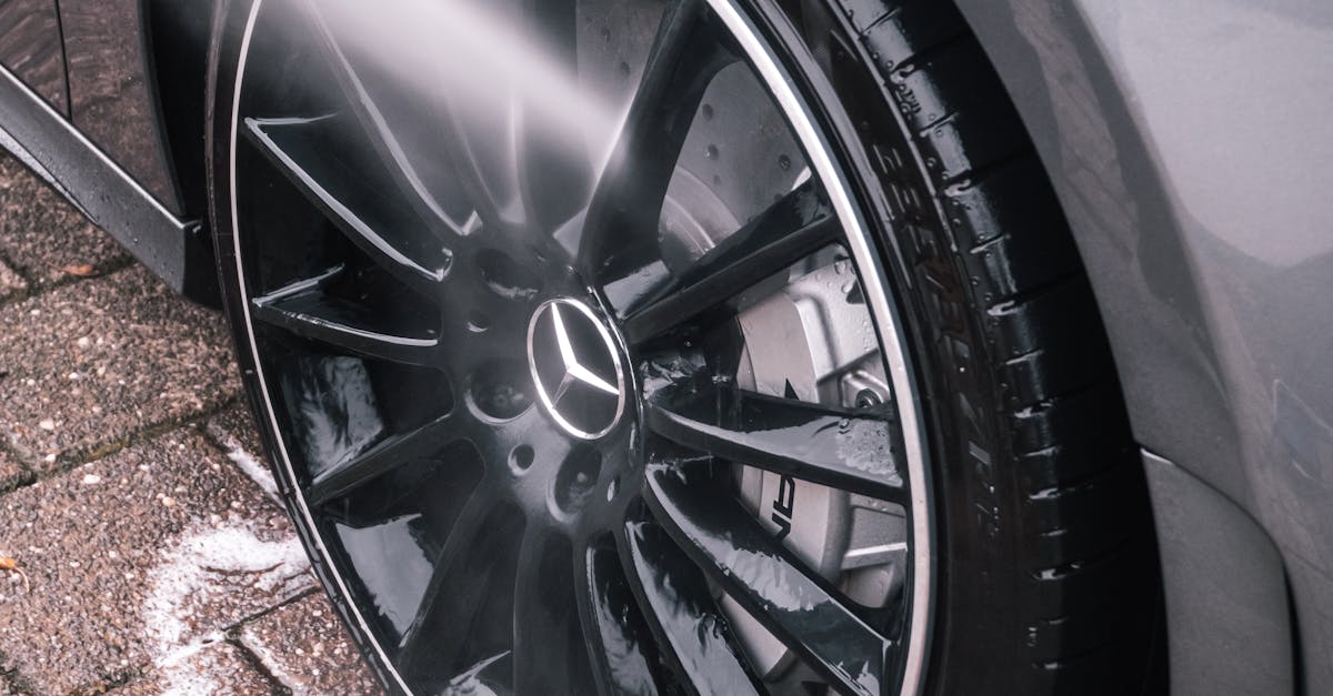 Close up of Water Stream Cleaning Car Wheel